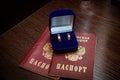Wedding ring. Two gold vintage rings of the bride and groom are in a blue velvet box and a passport of the Russian Federation