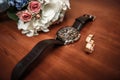 Wedding ring and watch groom on the table