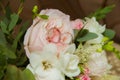 Wedding ring in white gold. Two platinum rings of the bride and groom and a bouquet of pink roses and white flowers Royalty Free Stock Photo