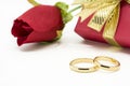 Wedding rings and artificial rose on white background Royalty Free Stock Photo