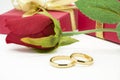 Wedding rings and artificial rose on white background Royalty Free Stock Photo