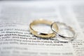 Wedding rings on Bible scripture Royalty Free Stock Photo