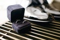 Wedding rings in a black box close-up. Groom`s shoes with wedding rings. Free space for text Royalty Free Stock Photo