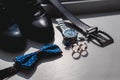 Wedding rings. Black leather shoes, watch, blue bow tie and cufflinks, on a white window sill. Royalty Free Stock Photo