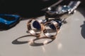 Wedding rings. Black leather shoes, watch, blue bow tie and cufflinks, on a white window sill. Royalty Free Stock Photo