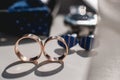 Wedding rings. Black leather shoes, watch, blue bow tie and cufflinks, on a white window sill. Royalty Free Stock Photo