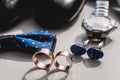 Wedding rings. Black leather shoes, watch, blue bow tie and cufflinks, on a white window sill. Royalty Free Stock Photo