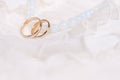 Wedding rings and blue beads Royalty Free Stock Photo