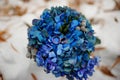 Wedding rings on blue bouquet at winter day.