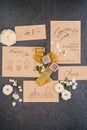 Wedding rings in a box, invitation cards, silk ribbon, white roses on a black background. Overhead top view. Royalty Free Stock Photo