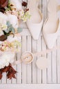 Wedding rings in a box stand on the table near the bride shoes and a bouquet of flowers. Top view Royalty Free Stock Photo