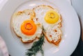 Wedding rings with breakfast two eggs fried Royalty Free Stock Photo
