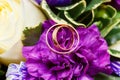 Wedding rings on bridal bouquet of flowers Royalty Free Stock Photo