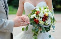 Wedding rings bride and groom on the background of the bouquet Royalty Free Stock Photo