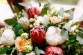 Wedding rings of the bride and groom on a bud in a bouquet of roses and peonies in red and white. Royalty Free Stock Photo