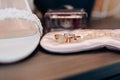 Wedding rings of the bride and groom close-up against the background of a bouquet of flowers and shoes Royalty Free Stock Photo