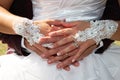 Wedding rings on bride and groom fingers hands on marriage white dress background during outdoor celebration Royalty Free Stock Photo
