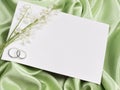 Wedding rings, card and lily of the valley Royalty Free Stock Photo