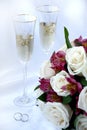 Wedding rings, champagne and flowers Royalty Free Stock Photo