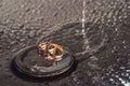 Wedding rings on a chrome plated surface. water drops with reflections of light. water splashes Royalty Free Stock Photo