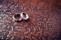 Wedding rings close-up on a brown background