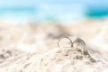 Wedding rings for couple lover on the sandy beach. Engagement rings in honeymoon vacation in tropics. Valentine Concept. Royalty Free Stock Photo