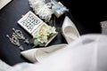 Wedding rings in a decorative box with flowers, earrings, women`s shoes, a garter of the bride, a small gift Royalty Free Stock Photo