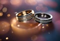 wedding rings are on display with glitter and lights in the background Royalty Free Stock Photo