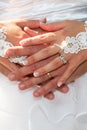 Wedding rings fingers on bride groom hands on white dress background Royalty Free Stock Photo