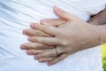 Wedding rings fingers on couple marriage bride groom hands on white dress background Royalty Free Stock Photo