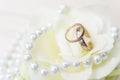 Wedding rings on a flower with pearls Royalty Free Stock Photo