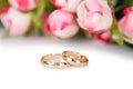 The wedding rings and flowers isolated on white background Royalty Free Stock Photo