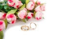 The wedding rings and flowers isolated on white background Royalty Free Stock Photo
