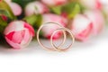 The wedding rings and flowers isolated on white background Royalty Free Stock Photo