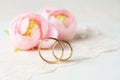 Wedding rings with flowers on lace.