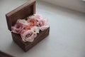 Wedding rings on flowers in old rustic wooden box for wedding ceremony