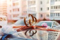 Wedding rings, flowers and ribbon on the roof of the car on the background of city buildings Royalty Free Stock Photo