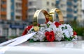 Wedding rings, flowers and ribbon on the roof of the car Royalty Free Stock Photo