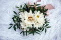 Wedding rings, gold and diamond on a white chrysanthemum, close-up. Two beautiful rings on the wedding bouquet, top view Royalty Free Stock Photo