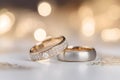 Wedding rings from gold and diamonds on light bokeh background. Gold wedding rings. Luxury rings for wedding, proposal. Saint Royalty Free Stock Photo