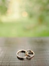 Golden wedding rings on wooden surface Royalty Free Stock Photo