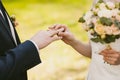 Wedding rings and hands of bride and groom. Royalty Free Stock Photo