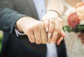 Wedding rings and the hands of the groom and the bride Royalty Free Stock Photo