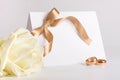 Wedding rings and invite with rose Royalty Free Stock Photo