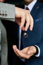 Wedding rings, levitation items. The groom holds the rings