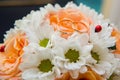 Wedding rings lie on a bouquet of orange roses and white colors. Ladybug. Royalty Free Stock Photo