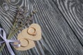 Wedding rings lie on hearts cut out of paper. Near a bunch of lavender. On brushed pine boards painted in black and white Royalty Free Stock Photo