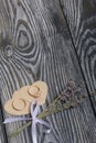 Wedding rings lie on hearts cut out of paper. Near a bunch of lavender. On brushed pine boards painted in black and white Royalty Free Stock Photo