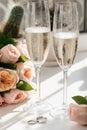 Wedding rings lie next to two glasses of champagne and a bouquet of roses Royalty Free Stock Photo