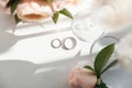 Wedding rings lie next to two glasses of champagne and a bouquet of roses Royalty Free Stock Photo